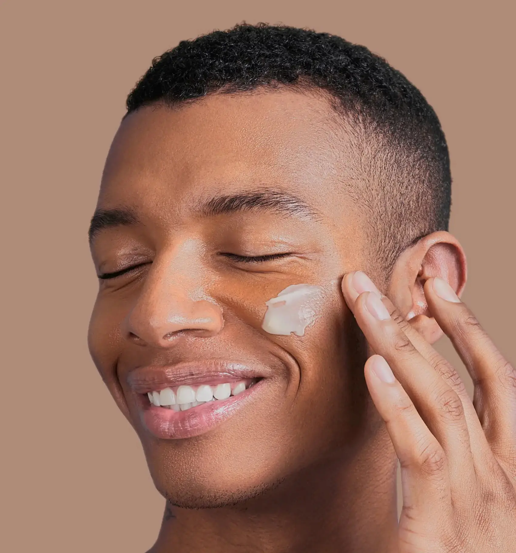 Man smiling with cream on his face