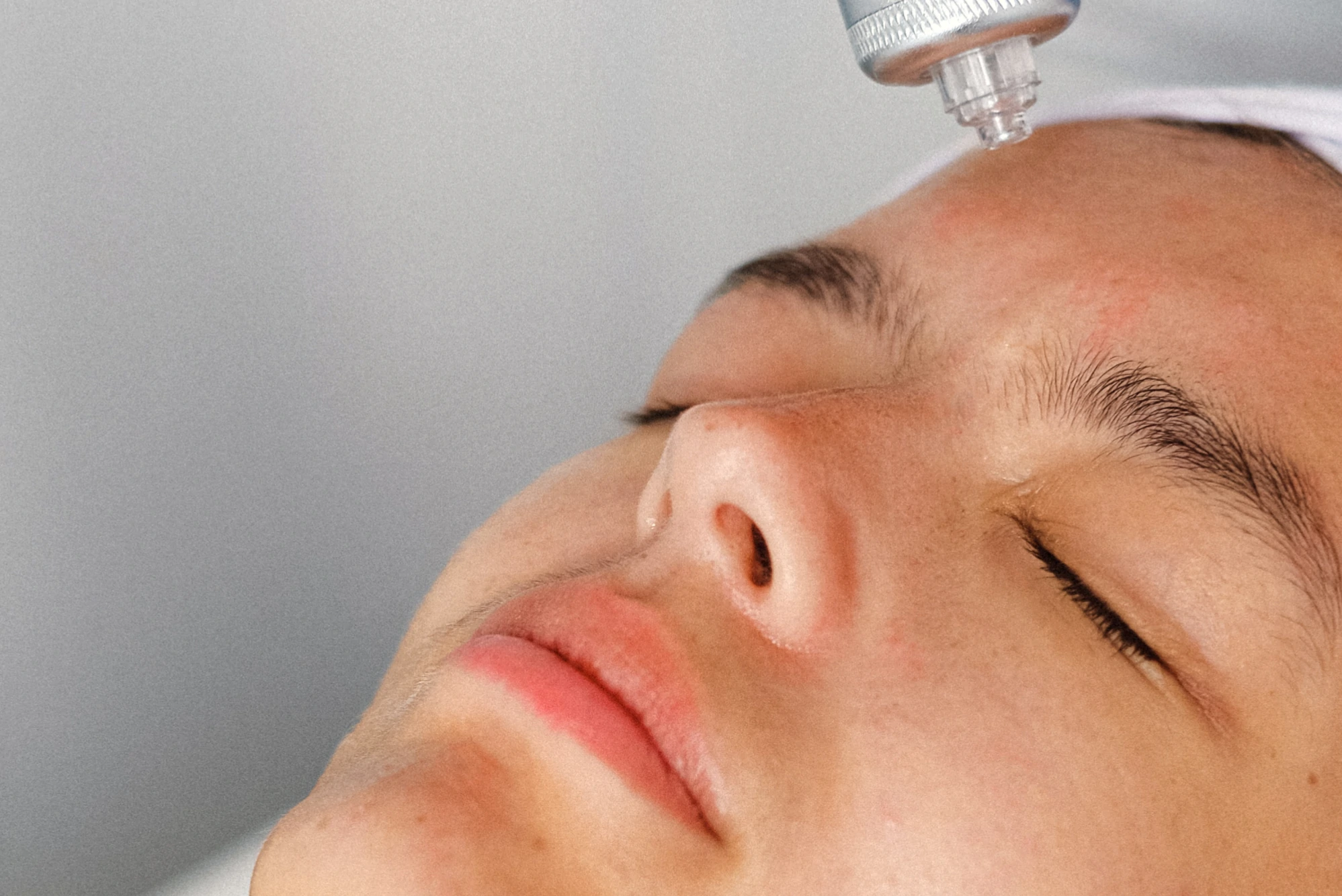Close up of a specialist making face skin procedure with modern equipment